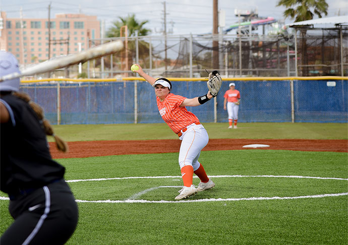 Softball pitcher prepares to throw ball