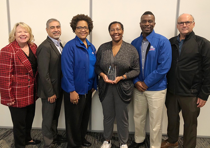 Six members of the Galveston College faculty pose with an award.