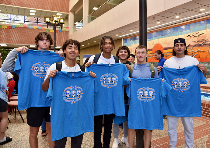 6 students pose with HHM Fiesta Day shirts.