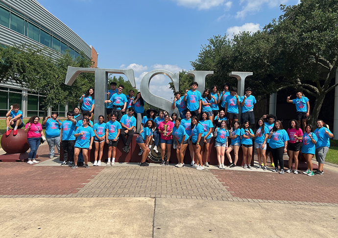 Upward bound students pose in front on TSU sign.