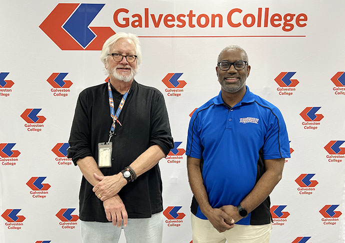 Two people stand in front of Galveston College logo wall