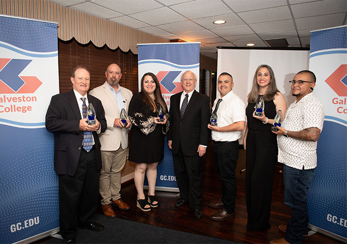 7 GC faculty and staff stand with awards