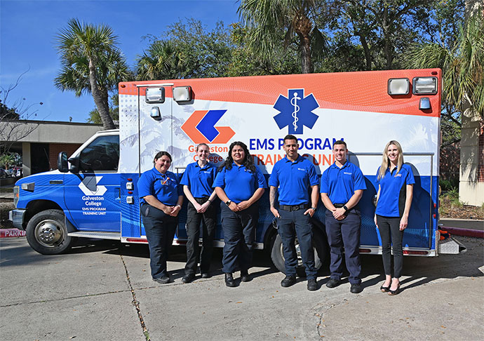 EMS students stand in front of ambulance