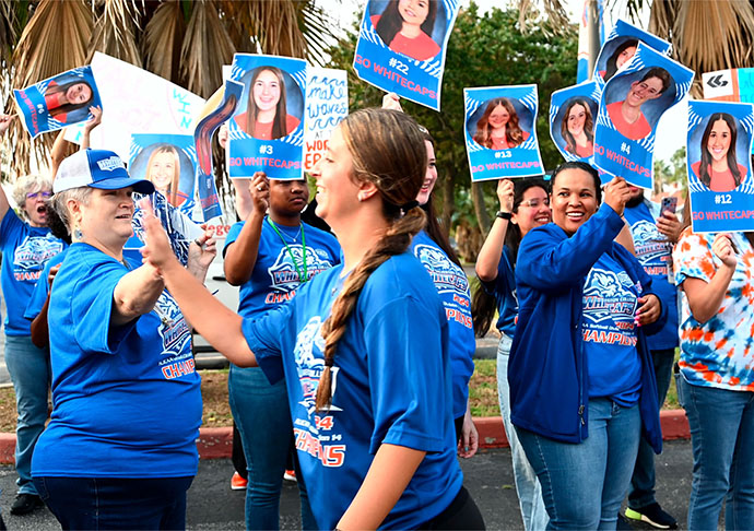 Fans cheer for softball send off with signs