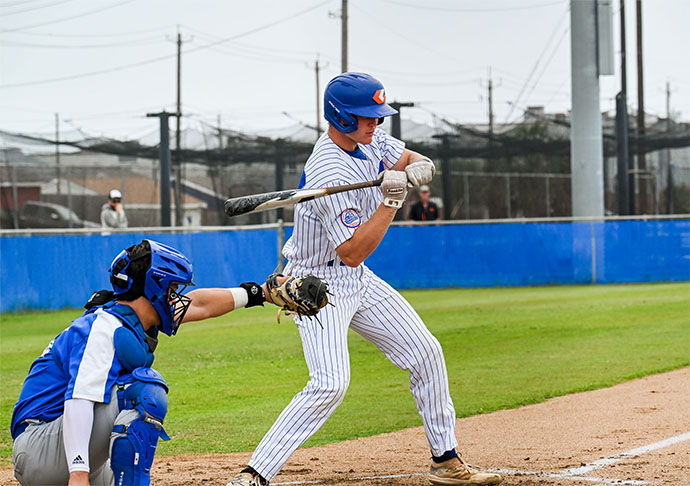 Baseball plater at bat swings