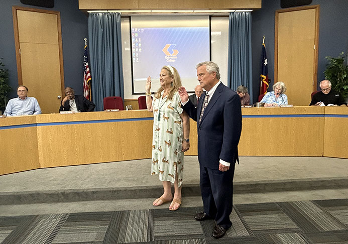 Two people are sworn into office in front of council