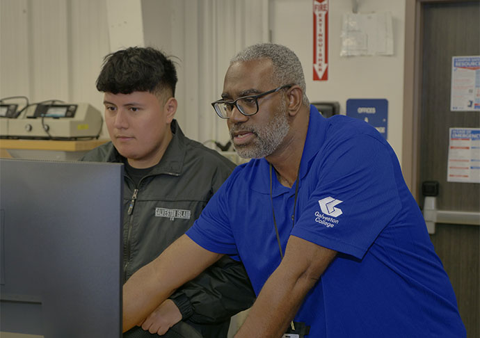 Galveston College Electrical and Electronics Technology Program Director, Tyree Bearden, helps a student during class at the Galveston College Charlie Thomas Family Applied Technology Center.