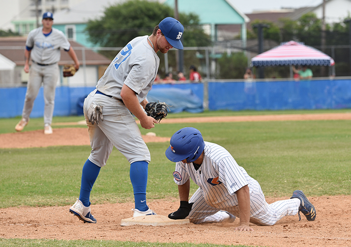 Baseball player slides into plate.