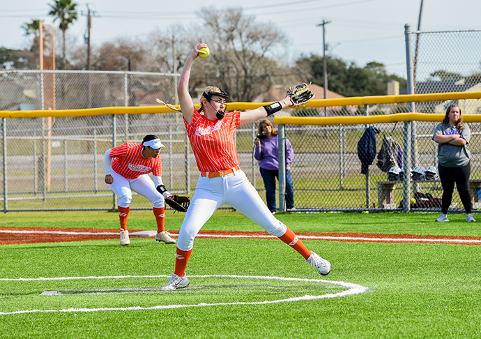 Softball pitcher throws out ball