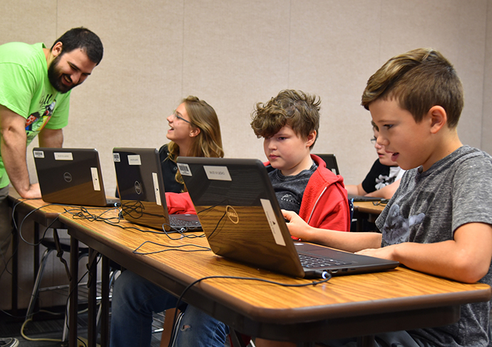 Students work on computers.